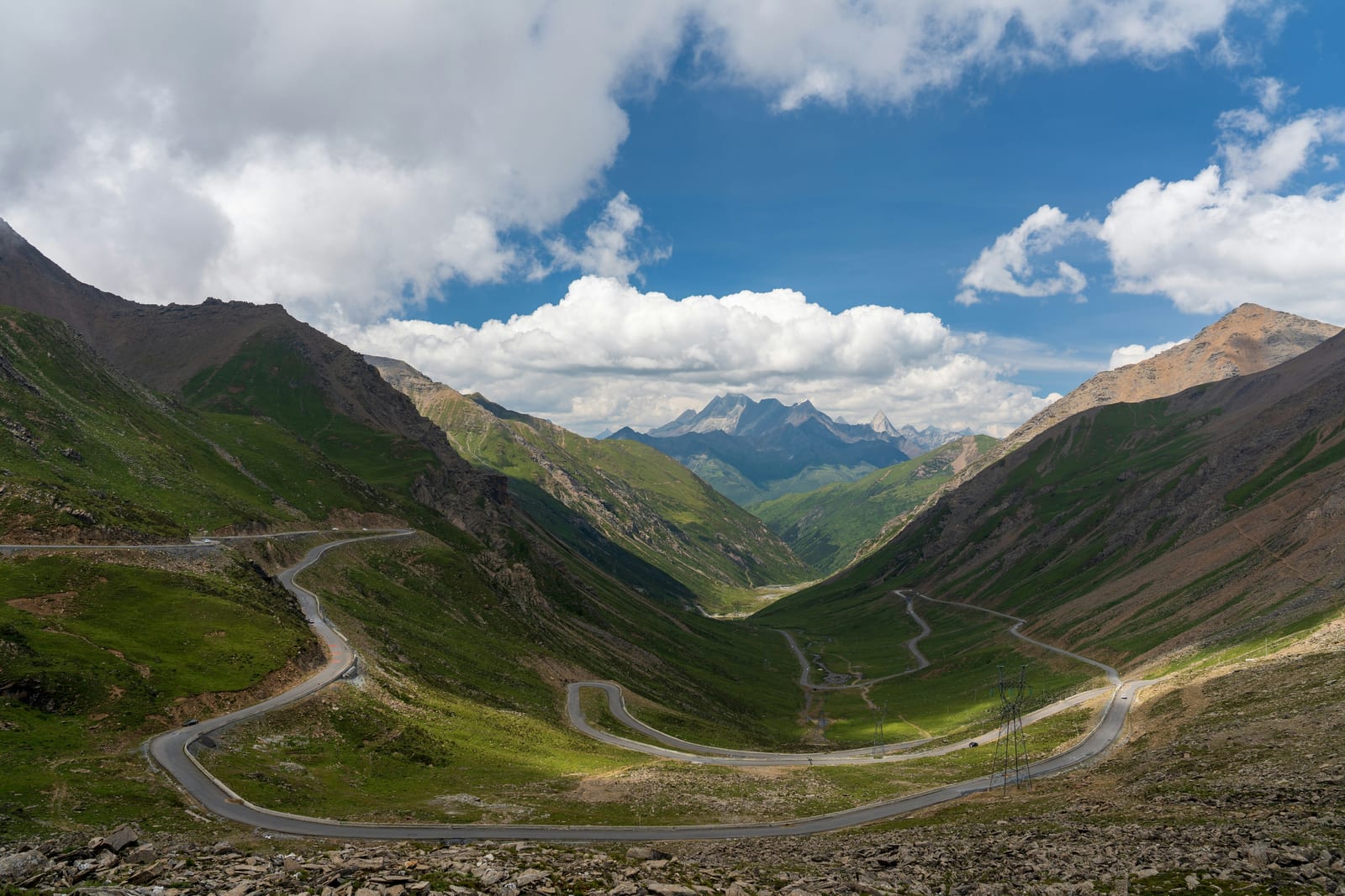Mountain road switchbacks through the valley at Balangshan Pass