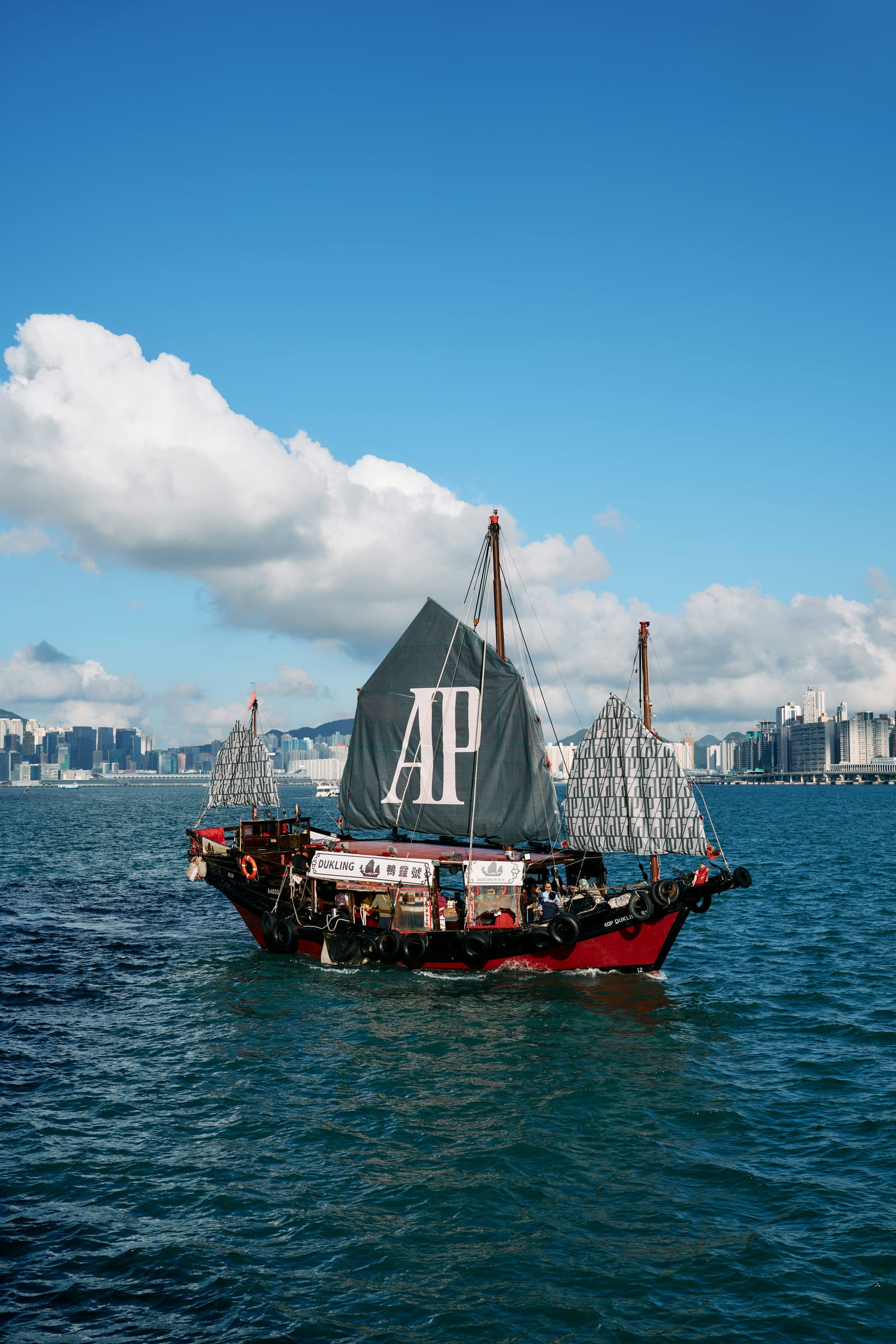 Traditional sailing boat and skyline in Victoria Harbour