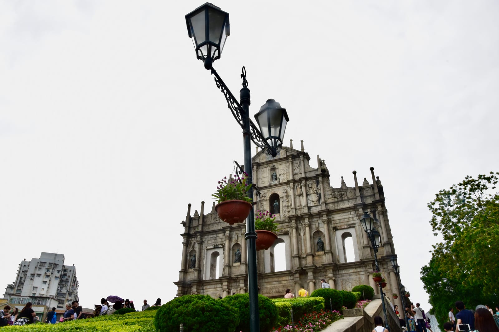 Facade, stone steps, street lamps and visitors at the Ruins of Saint Paul in Macao