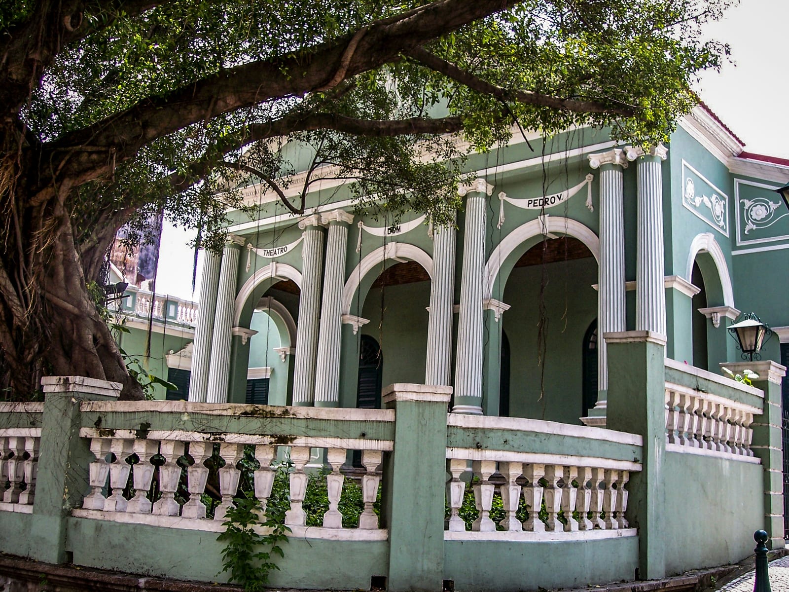 Green arcades and trees at Dom Pedro V Theatre in Macau