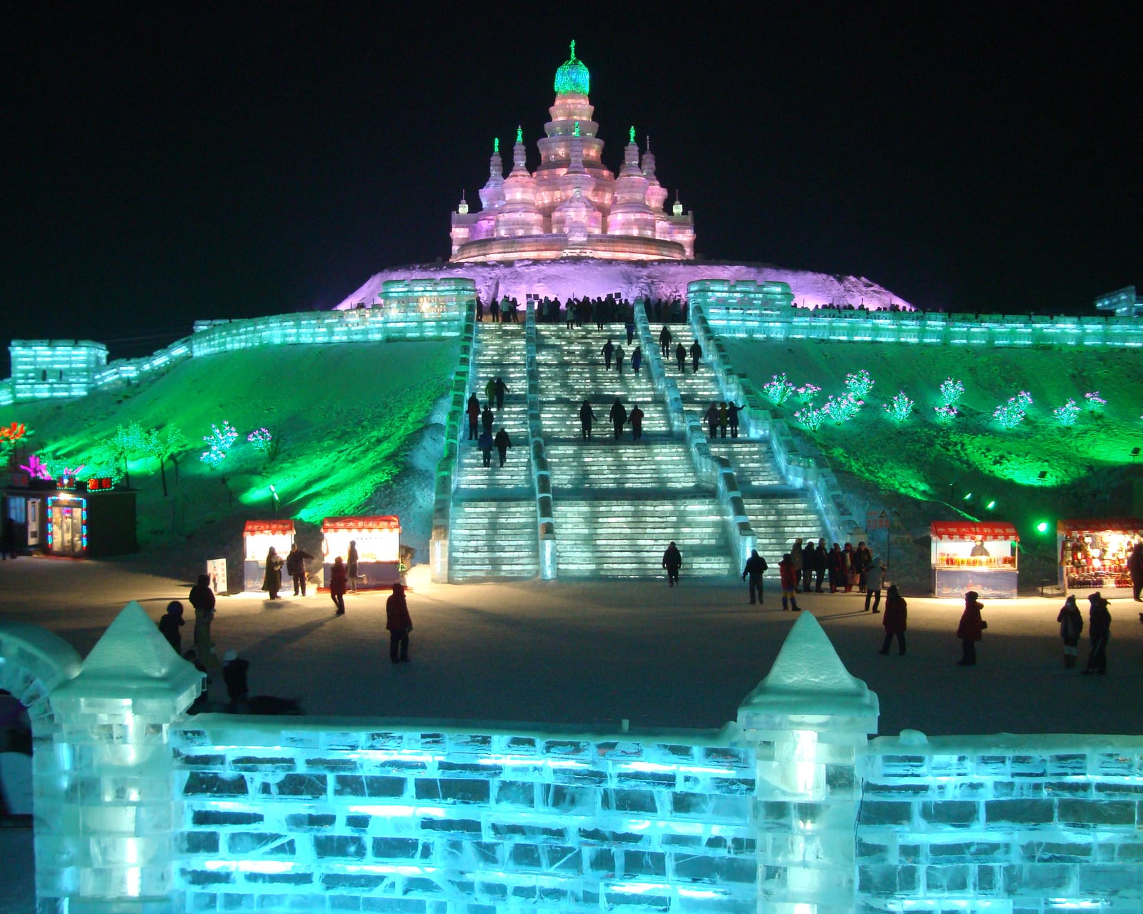 Illuminated ice architecture, coloured lights and visitors at Harbin Ice and Snow World