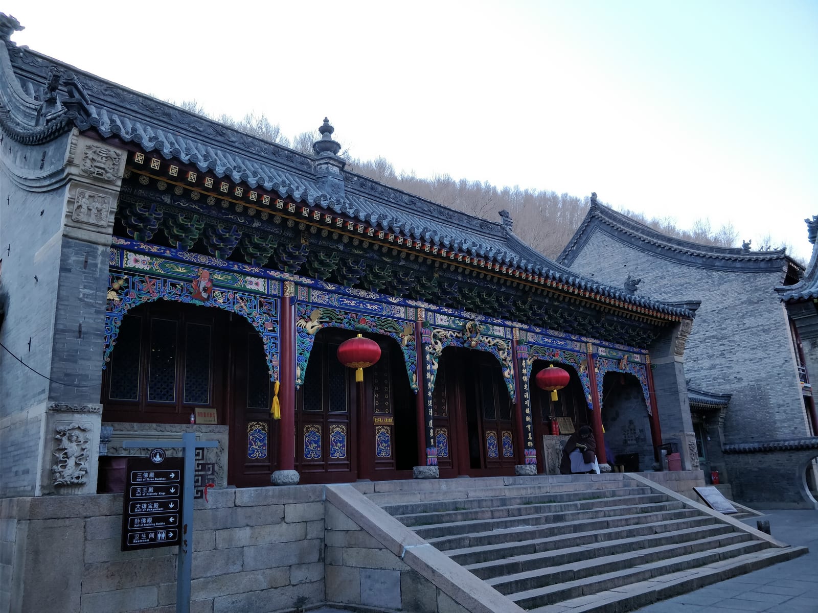 Temple halls, courtyard and wooded mountain at Puhua Temple on Mount Wutai